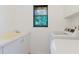 Laundry room featuring a utility sink and modern appliances at 1974 Hidden Springs Pl, Clearwater, FL 33760