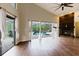 Open living room with fireplace and sliding glass doors to screened pool area at 1974 Hidden Springs Pl, Clearwater, FL 33760