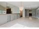 Elegant living room with a decorative chandelier, tile flooring, and views into other living spaces at 1974 Hidden Springs Pl, Clearwater, FL 33760