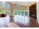 Spacious living area with a vaulted ceiling, fireplace, wood floors, and access to the screened lanai and pool at 1974 Hidden Springs Pl, Clearwater, FL 33760
