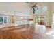 Spacious living room featuring hardwood floors, a dry bar, high ceilings, and access to a patio and dining area at 1974 Hidden Springs Pl, Clearwater, FL 33760
