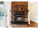 Living room fireplace with stone surround and wooden mantle with a view of the pool at 1974 Hidden Springs Pl, Clearwater, FL 33760