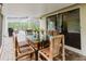 Outdoor dining area boasts a table and chair set beneath a covered patio adjacent to the home's pool area at 1974 Hidden Springs Pl, Clearwater, FL 33760