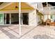 The home's outdoor living space features sliding glass doors and a paved patio and outdoor seating area at 1974 Hidden Springs Pl, Clearwater, FL 33760