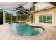 The in-ground pool features a waterfall and a screened enclosure at 1974 Hidden Springs Pl, Clearwater, FL 33760