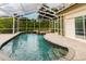 A pristine screened-in pool with a waterfall spa and a spacious patio for outdoor enjoyment at 1974 Hidden Springs Pl, Clearwater, FL 33760