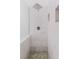Walk-in shower with marble tile and mosaic floor at 1974 Hidden Springs Pl, Clearwater, FL 33760