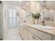 Bright bathroom featuring double vanity, neutral stone countertops, and a glass enclosed shower at 2006 Tanglewood Ne Dr, St Petersburg, FL 33702