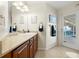 Bright bathroom featuring cherry cabinets, stone countertop and view to the pool area at 2006 Tanglewood Ne Dr, St Petersburg, FL 33702