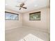 Comfortable bedroom with two large windows providing natural light and a ceiling fan at 2006 Tanglewood Ne Dr, St Petersburg, FL 33702