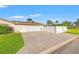 Home exterior with driveway, two-car garage and fenced side yard at 2006 Tanglewood Ne Dr, St Petersburg, FL 33702