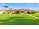 Lovely single-story home featuring an expansive green front lawn and stone walkway at 2006 Tanglewood Ne Dr, St Petersburg, FL 33702