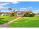 Inviting single-story home featuring a lush front lawn and stone-paved walkway at 2006 Tanglewood Ne Dr, St Petersburg, FL 33702