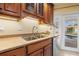 Kitchen sink and countertop with a view of the pool at 2006 Tanglewood Ne Dr, St Petersburg, FL 33702