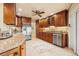 Eat-in kitchen featuring wood cabinets, stainless steel appliances, and tile floors with an adjacent dining area and lots of counter space at 2006 Tanglewood Ne Dr, St Petersburg, FL 33702