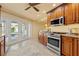 Kitchen with stainless steel appliances and access to the pool area through glass doors at 2006 Tanglewood Ne Dr, St Petersburg, FL 33702