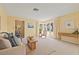 Bright living room filled with natural light with neutral walls, neutral carpet flooring, furniture, and decorations at 2006 Tanglewood Ne Dr, St Petersburg, FL 33702
