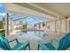 Screened-in pool area with chairs provides a relaxing outdoor space at 2006 Tanglewood Ne Dr, St Petersburg, FL 33702