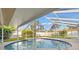 Refreshing screened-in pool surrounded by lush landscaping, perfect for outdoor enjoyment at 2006 Tanglewood Ne Dr, St Petersburg, FL 33702