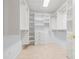 Spacious walk-in closet with custom shelving and drawers for ample storage in a home at 2006 Tanglewood Ne Dr, St Petersburg, FL 33702