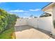 A paved area with a gated fence, landscaping, and a well maintained lawn at 2006 Tanglewood Ne Dr, St Petersburg, FL 33702