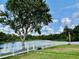 Backyard view with a tranquil pond and white picket fence, offering a private and peaceful setting at 23112 Emerson Way, Land O Lakes, FL 34639