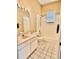 Well-lit bathroom with a tub-shower combo and single sink vanity at 23112 Emerson Way, Land O Lakes, FL 34639
