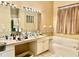 Bathroom with soaking tub, neutral color palette, and expansive vanity at 23112 Emerson Way, Land O Lakes, FL 34639