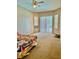 Spacious carpeted bedroom with ceiling fan, large windows, and sliding door at 23112 Emerson Way, Land O Lakes, FL 34639