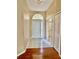 Inviting foyer with tile flooring, a decorative front door, and neutral paint at 23112 Emerson Way, Land O Lakes, FL 34639