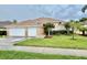 Charming single-story home with a well-manicured lawn and a three-car garage at 23112 Emerson Way, Land O Lakes, FL 34639