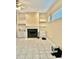 Cozy living room with a fireplace, built-in shelving, and tile flooring at 23112 Emerson Way, Land O Lakes, FL 34639