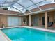 Inviting backyard pool with a screened-in patio, ideal for enjoying sunny days and relaxing evenings at 23112 Emerson Way, Land O Lakes, FL 34639