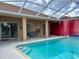 Backyard pool with an enclosed patio, perfect for outdoor gatherings and relaxation by the water at 23112 Emerson Way, Land O Lakes, FL 34639