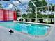 Screened-in pool with clear blue water and a beautiful backyard view, perfect for relaxation at 23112 Emerson Way, Land O Lakes, FL 34639