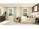 Bright bedroom with large windows, a comfortable bed, and a relaxing seating area, perfect for unwinding at 234 Se 27Th St, Ruskin, FL 33570