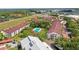 A bird's eye view of the community featuring a pool, multiple buildings, and mature trees at 2581 Countryside Blvd # 2309, Clearwater, FL 33761