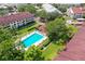 An aerial view of the community featuring a pool, multiple buildings, and mature landscaping at 2581 Countryside Blvd # 2309, Clearwater, FL 33761