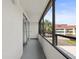 Long, screened balcony with white walls showing neighborhood views at 2581 Countryside Blvd # 2309, Clearwater, FL 33761