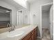 Bathroom features wood cabinets, a light countertop, a large mirror and access to a closet at 2581 Countryside Blvd # 2309, Clearwater, FL 33761