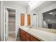 Bathroom has a shower with updated tile and wood cabinets, a light countertop and large mirror at 2581 Countryside Blvd # 2309, Clearwater, FL 33761