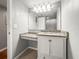 Bathroom featuring a granite vanity, sink and mirror, complemented by neutral paint at 2581 Countryside Blvd # 2309, Clearwater, FL 33761