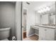 Bathroom includes a toilet, granite vanity, tiled floors, and new fixtures at 2581 Countryside Blvd # 2309, Clearwater, FL 33761