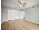 Bright bedroom featuring light wood flooring, a ceiling fan and a spacious closet at 2581 Countryside Blvd # 2309, Clearwater, FL 33761