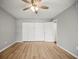 Bright bedroom featuring light wood flooring, a ceiling fan and a spacious closet at 2581 Countryside Blvd # 2309, Clearwater, FL 33761