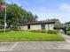 Well-maintained building with lush landscaping, an American flag, and controlled access at 2581 Countryside Blvd # 2309, Clearwater, FL 33761
