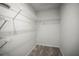 Walk-in closet features white wire shelving and neutral carpet at 2581 Countryside Blvd # 2309, Clearwater, FL 33761