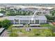 Condo building featuring well-maintained landscaping, covered parking, and proximity to shopping centers at 2581 Countryside Blvd # 2309, Clearwater, FL 33761