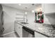 Kitchen boasts granite countertops, stainless steel dishwasher, and modern pendant lighting at 2581 Countryside Blvd # 2309, Clearwater, FL 33761