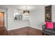 Cozy living room featuring hardwood floors, an elegant chandelier, and a view of the kitchen at 2581 Countryside Blvd # 2309, Clearwater, FL 33761